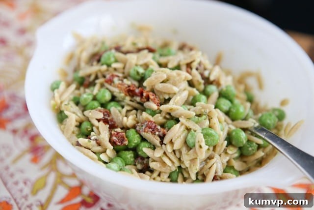 Vibrant Whole Wheat Orzo with Pesto and Sweet Peas 3 Close-up of Orzo Pasta with Vibrant Pesto, Green Peas, and Sun-Dried Tomatoes