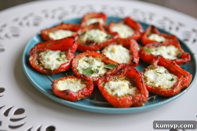 Close-up of roasted red peppers with melted goat cheese and green pesto, ready to be served as an appetizer.