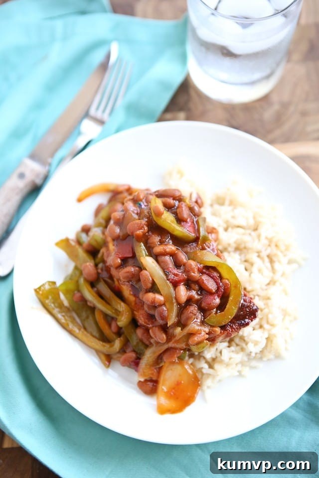Grilled Pork Chops smothered in a special sauce made with baked beans, peppers and onions. So flavorful and an easy dinner to make - perfect for grilling season!