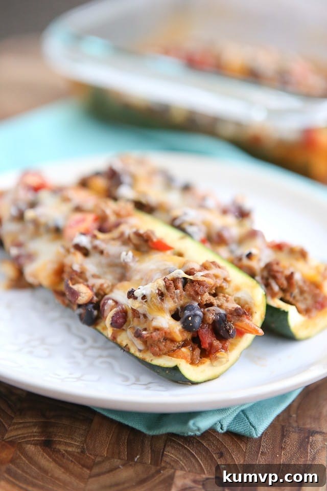 Chili Stuffed Zucchini Boats: The ultimate low-carb, filling, and easy dinner using leftover chili! Delicious Chili Stuffed Zucchini Boats, a perfect low-carb way to enjoy leftover chili. Great for healthy dinners and meal prep.