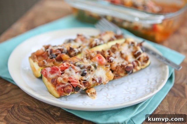 Leftover Chili Stuffed Zucchini Boats: A healthy, low-carb, and delicious dinner solution. Close-up of Chili Stuffed Zucchini Boats, showing the rich chili filling and melted cheese, ideal for a low-carb and satisfying meal.