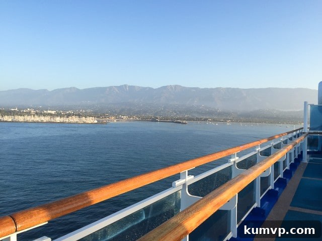 Scenic Island View from Cruise Ship A serene view of an island from the deck of a cruise ship, emphasizing the beautiful travel experience.