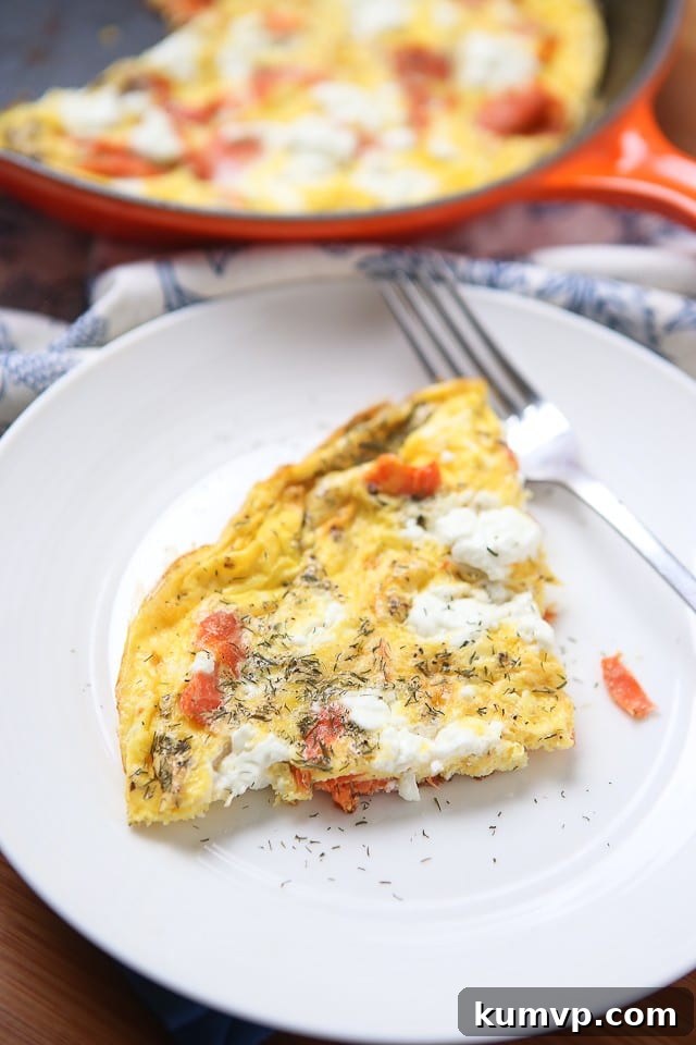 Smoked Salmon Frittata Close-up Close-up of a cooked Smoked Salmon Frittata, showcasing the rich texture, salmon pieces, and melted goat cheese.
