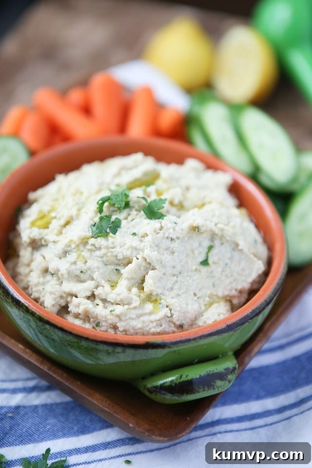 Creamy Lemony Artichoke Hummus served with fresh vegetables and pita chips, a perfect healthy snack or appetizer.