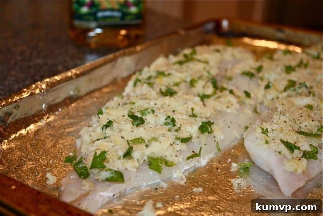 Zesty Oregano Baked Fish 3 baked fish on a plate with lemon wedge