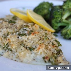 baked breaded fish on a plate with lemon