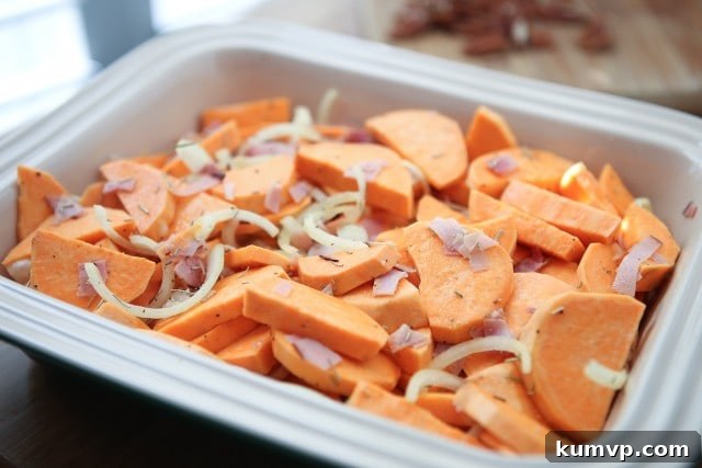 Close-up of golden brown Savory Sweet Potato Gratin with visible layers and crunchy pecans.