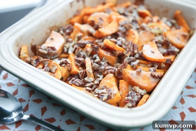 A side shot of the prepared Savory Sweet Potato Gratin, highlighting the crispy Parmesan-pecan topping.