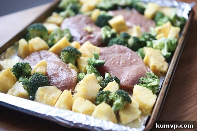 A sheet pan supper for busy weeknights - this Chinese Five Spice Pork Chops with Broccoli is easy to make and delicious. Delicious Chinese Five Spice Pork Chops with tender roasted broccoli and sweet caramelized pineapple chunks, a family-approved healthy dinner.