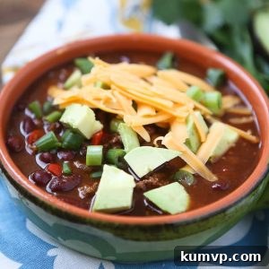 A vibrant bowl of Chipotle Chicken Chili, richly garnished, ready to be served. This recipe from Aggie's Kitchen is highly rated and perfect for a comforting meal.