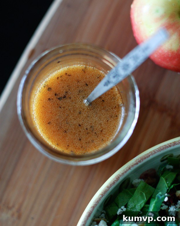 Sweet & Smoky Maple Vinaigrette Dressing with Apple Cider Vinegar overhead shot of maple vinaigrette in a jar with spoon, ready to be served over fresh greens