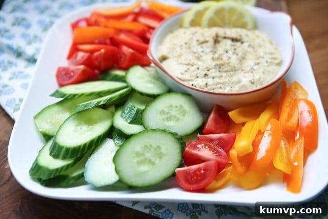 Zesty Lemon Pepper Hummus Garden Platter with Sabra Coupon 4 In need of an easy appetizer? Everyone loves a veggie plate! Spruce it up by serving fresh veggies with semi-homemade Lemon Pepper Hummus. Recipe via aggieskitchen.com #UnofficalMeal #NationalHummusDay