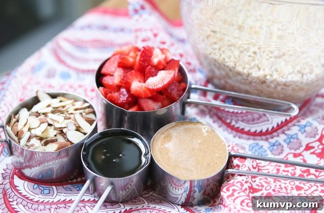 Delicious Strawberry Almond Baked Steel Cut Oatmeal with fresh berries, perfect for a healthy and satisfying meal prep breakfast. Serve with Greek yogurt and a drizzle of honey.