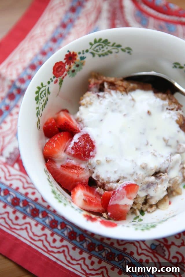 A close-up of a serving of Strawberry Almond Baked Steel Cut Oatmeal, showcasing its hearty texture and delicious ingredients. Ideal for quick, healthy breakfasts.