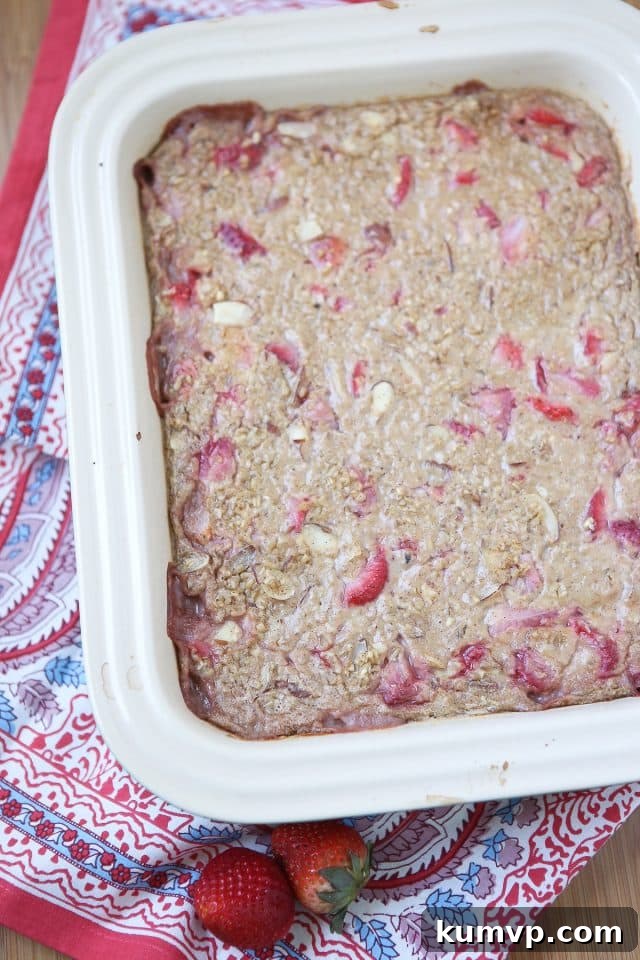 A vibrant and inviting dish of Strawberry Almond Baked Steel Cut Oatmeal, ready for serving or meal prepping. A healthy and delicious breakfast option for any day.