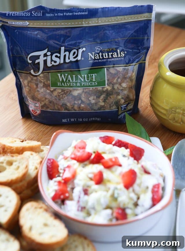 Strawberry Basil Chèvre Walnut Delight 2 An eye-catching close-up of the finished Strawberry Basil Goat Cheese Spread with Walnuts, presented on a rustic wooden board with crackers and a honey dipper, emphasizing its fresh ingredients and delicious texture for a summer get-together.