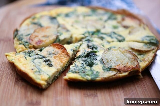 Green and Gold Frittata 4 Another view of the delicious Spinach and Potato Frittata, highlighting its golden-brown top and fluffy texture, perfect for any meal of the day.
