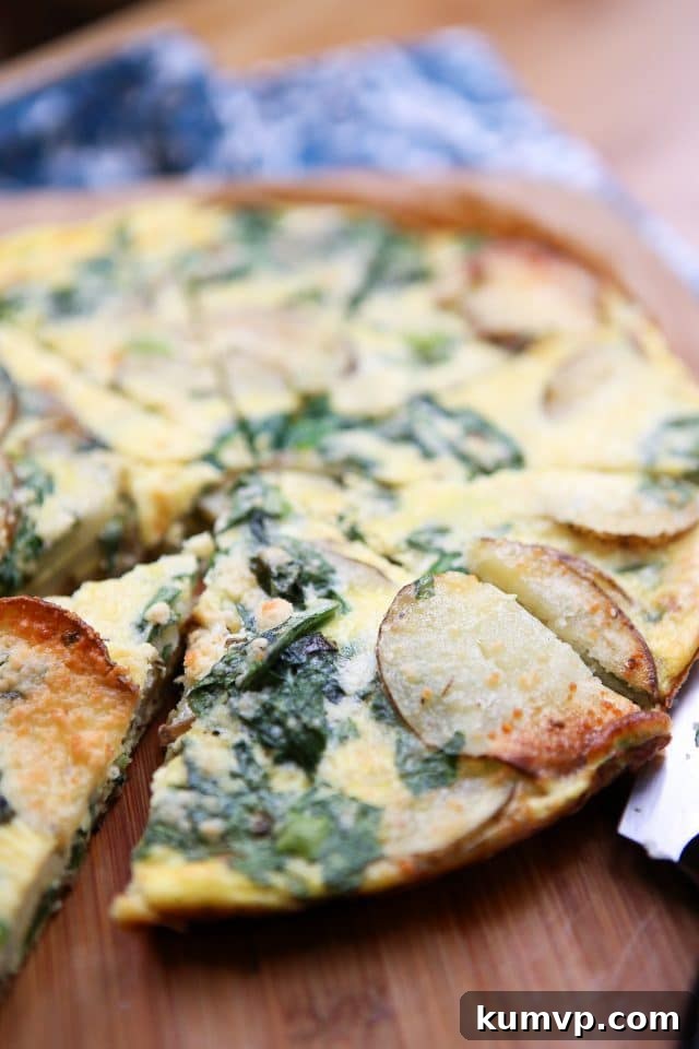 Green and Gold Frittata 5 A vertical shot of the Spinach and Potato Frittata, emphasizing its delicious texture and the fresh ingredients used. This frittata is a perfect blend of comfort and flavor.