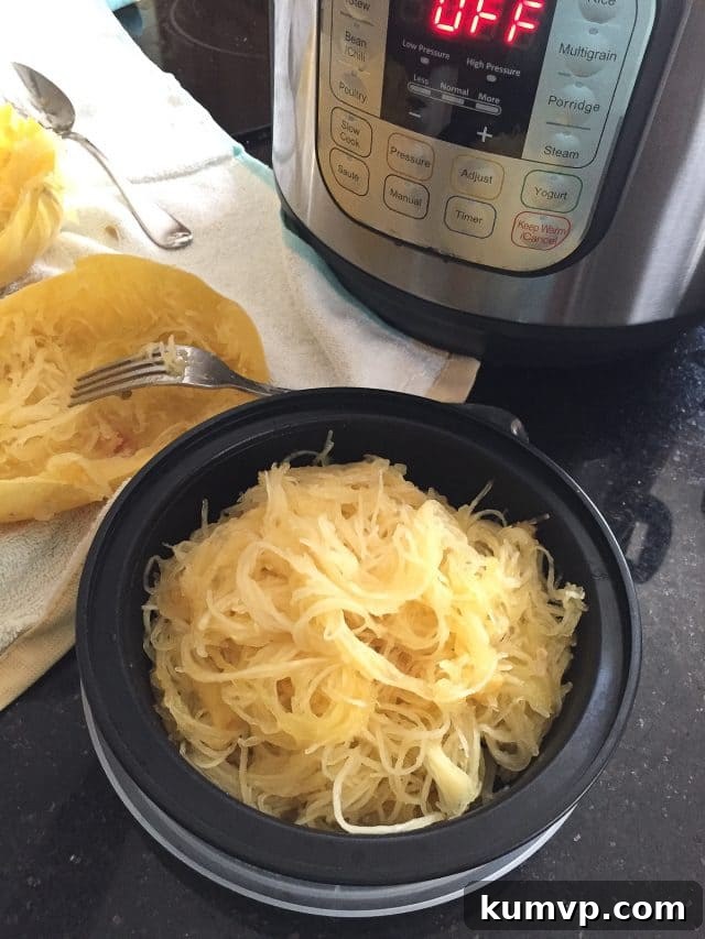 How To Cook Spaghetti Squash in the Instant Pot meal prep bowl filled with cooked spaghetti squash with instant pot on counter