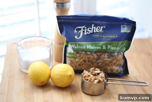 Ingredients for Parmesan Walnut Lemon Vinaigrette: jar of salt, pepper grinder, two lemons, pack of Fisher walnut halves and pieces, and measuring cup of walnuts