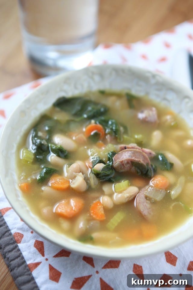 Hearty Smoked Sausage, White Bean and Spinach Soup, a popular comfort food recipe for chilly evenings