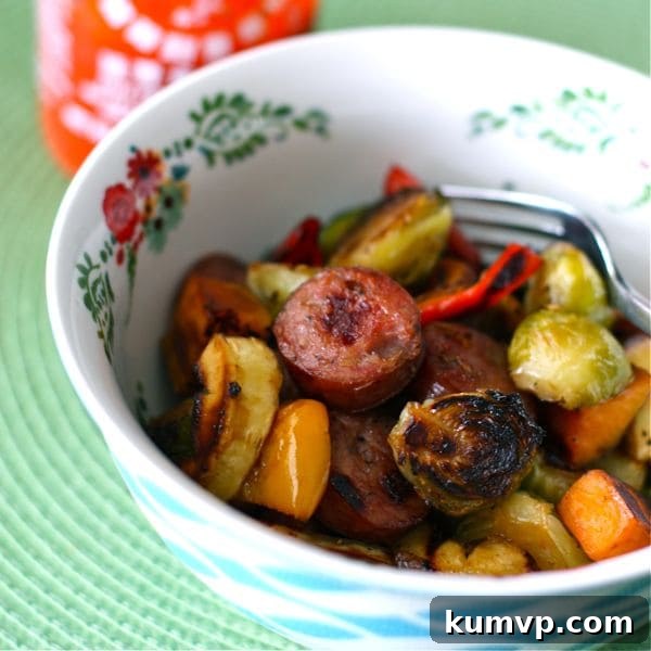 Maple Roasted Fall Vegetables with Chicken-Apple Sausage, a healthy and delicious sheet pan dinner for seasonal eating. Features sweet potatoes, broccoli, and flavorful chicken sausage.