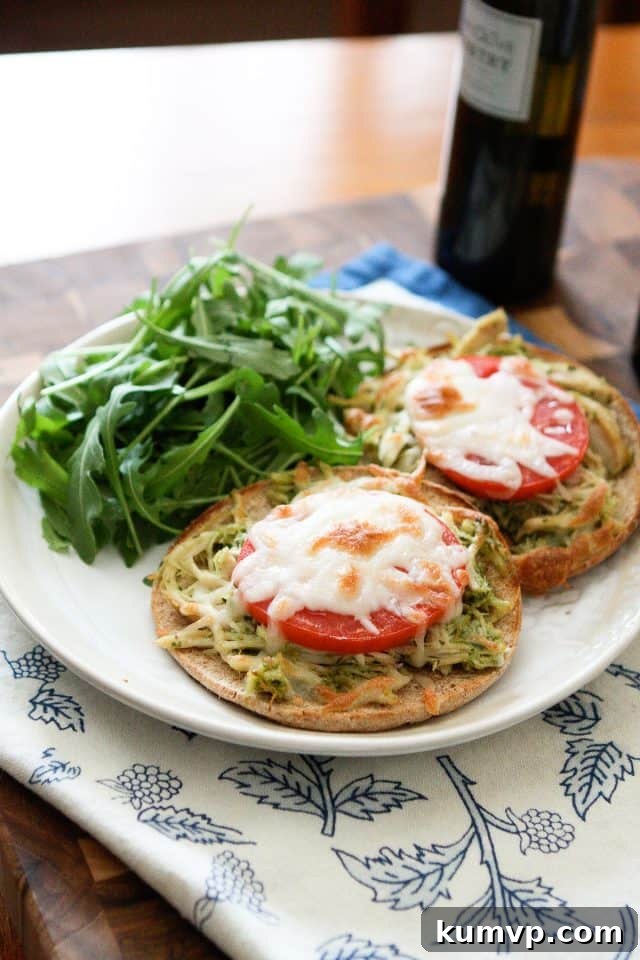 Tender Slow Cooker Pesto Chicken Melts, perfect for an easy and delicious dinner.