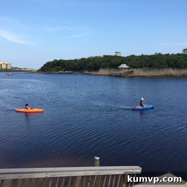 Kayaking on Big Redfish Lake, Blue Mountain Beach A lone kayak resting on the sandy shore of Big Redfish Lake, with calm waters reflecting the sky, inviting paddlers to explore.