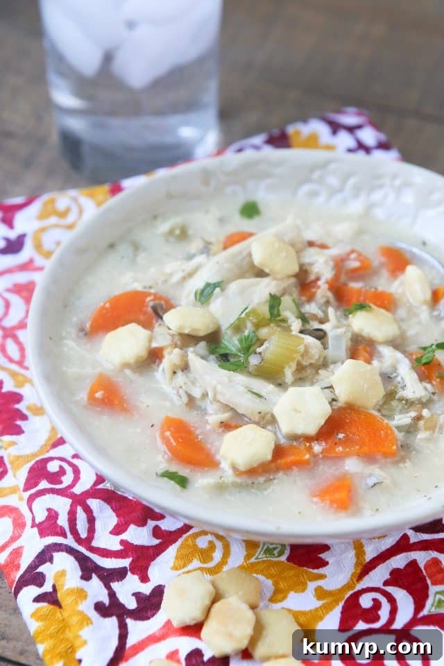 A delicious and comforting Slow Cooker Creamy Chicken and Wild Rice Soup, perfect for busy school nights. Made with fresh vegetables, chicken, wild rice, and creamy dairy, it's a hearty and nutritious meal the whole family will love. #ad #UndeniablyDairy @DairyGood