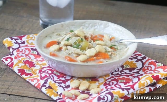 A vibrant and appetizing serving of Slow Cooker Creamy Chicken and Wild Rice Soup, ready to be enjoyed. This wholesome and easy-to-make soup is perfect for weeknight dinners, providing essential nutrients and comforting flavors for the whole family. #ad #UndeniablyDairy @DairyGood