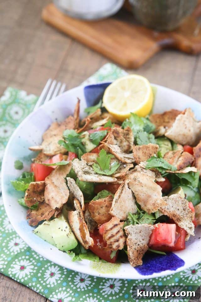 A colorful Fattoush Salad featuring crisp vegetables, fragrant herbs, and golden-brown pita croutons, glistening with lemon-olive oil dressing Vibrant Lebanese Fattoush Salad with fresh vegetables, herbs, and toasted pita, dressed with lemon and olive oil