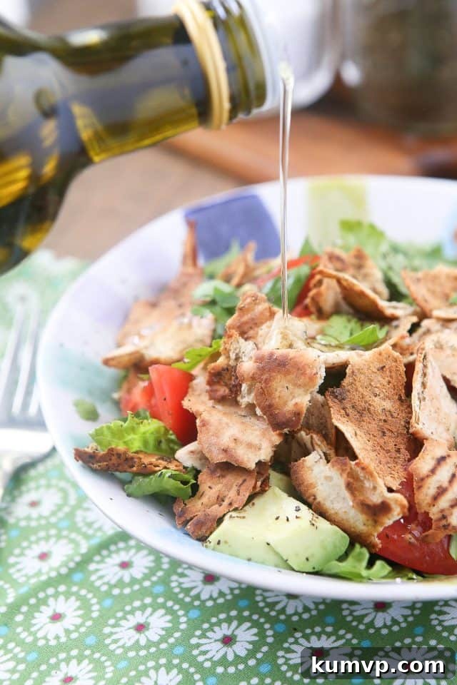 A vibrant bowl of Fattoush Salad, perfectly seasoned with a simple yet elegant lemon and olive oil dressing Fresh Fattoush Salad dressed simply with lemon and olive oil, highlighting the natural flavors