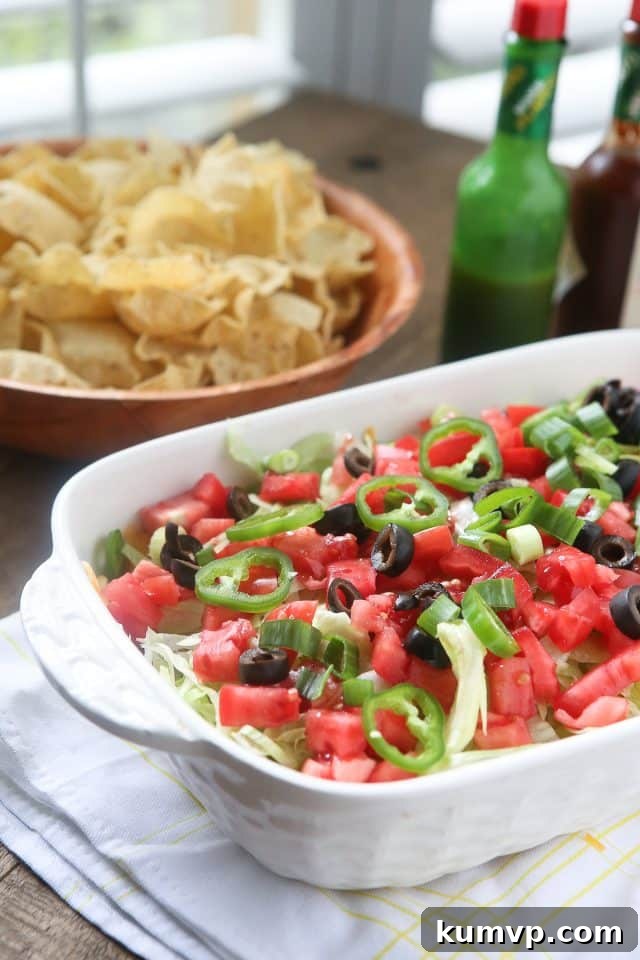 This Layered Taco Dip is full of all the ingredients that we love in our tacos, but in dip form. Great to serve while entertaining family and friends! #UndeniablyDairy #DairyGood #ad This Layered Taco Dip is full of all the ingredients that we love in our tacos, but in dip form. Great to serve while entertaining family and friends! #UndeniablyDairy #DairyGood #ad