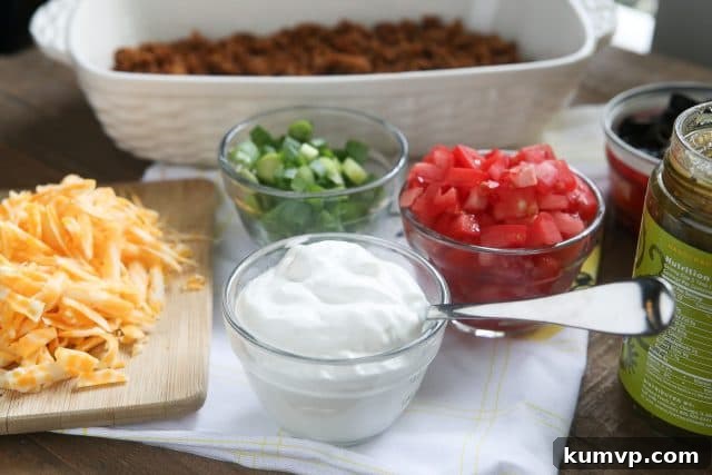 This Layered Taco Dip is full of all the ingredients that we love in our tacos, but in dip form. Great to serve while entertaining family and friends! #UndeniablyDairy #DairyGood #ad This Layered Taco Dip is full of all the ingredients that we love in our tacos, but in dip form. Great to serve while entertaining family and friends! #UndeniablyDairy #DairyGood #ad