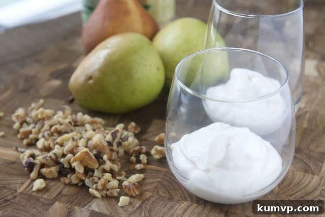 Enjoy the flavors of fall with a Greek Yogurt Parfait with Pears and Walnuts. Layers of creamy Greek yogurt, spiced pears and crunchy walnuts in every bite! Great snack or dessert idea using Greek yogurt. #ad #UndeniablyDairy @DairyGood