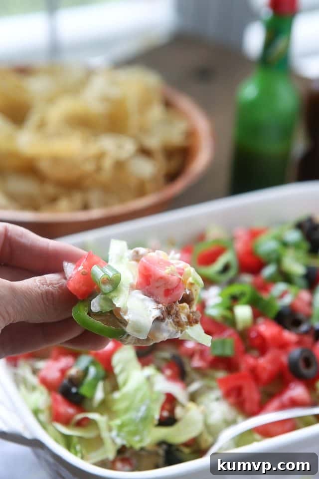 Layered Taco Dip, a crowd-pleasing appetizer perfect for parties and gatherings.