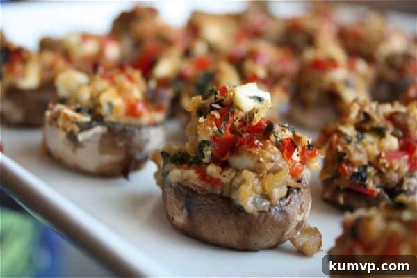 Sun-Drenched Mediterranean Mushroom Bites 2 Platter of freshly baked Mediterranean Stuffed Mushrooms, garnished with fresh herbs, ready to serve as an appetizer.