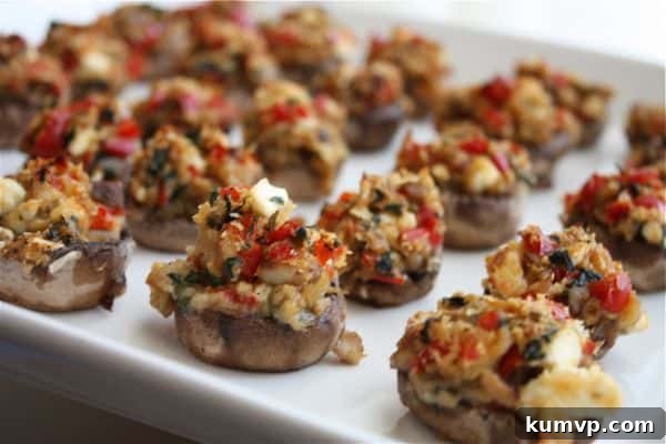 Sun-Drenched Mediterranean Mushroom Bites 3 Close-up view of Mediterranean Stuffed Mushrooms neatly arranged on a baking sheet, ready for the oven.