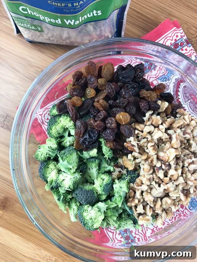 Freshly prepared Broccoli and Raisin Salad with crunchy walnuts, ready for a picnic. Freshly prepared Broccoli and Raisin Salad with crunchy walnuts, ready for a picnic.