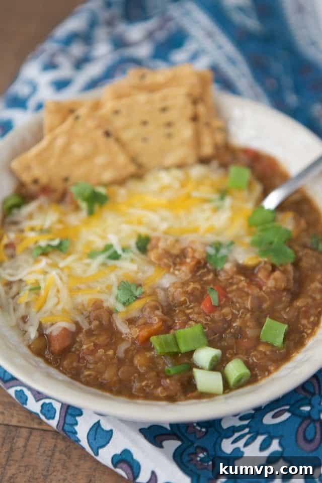 Pressure Cooker Plant Based Chili 2 Creamy Instant Pot Vegetarian Chili topped with melted cheese, fresh green onions, cilantro, and crunchy crackers. A perfect hearty, healthy, and satisfying meatless meal.