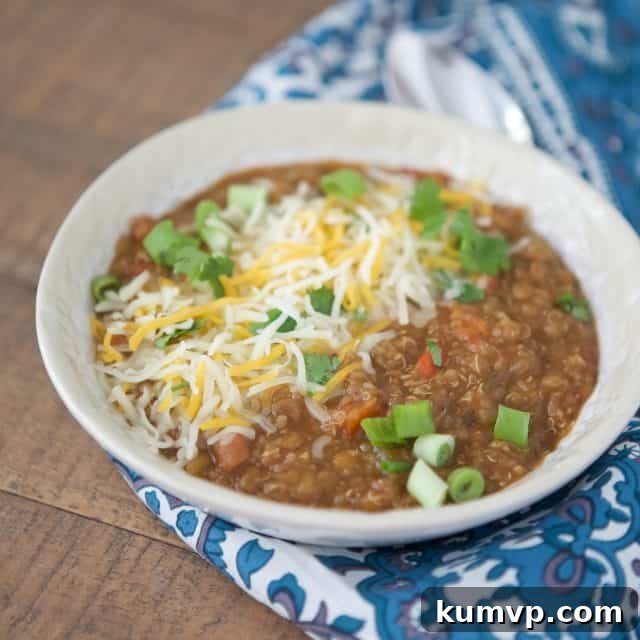 Pressure Cooker Plant Based Chili 3 Overhead view of a rustic bowl of vegetarian chili, showcasing its rich texture and diverse ingredients like lentils, beans, and vegetables, ready for delicious toppings.