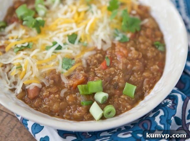 Pressure Cooker Plant Based Chili 5 A smaller bowl of Instant Pot Vegetarian Chili, freshly served with vibrant toppings like green onions and cilantro, ready to be enjoyed.
