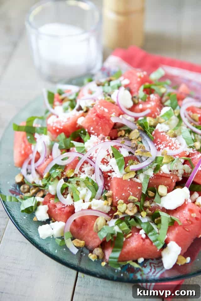 A vibrant bowl of Watermelon Feta Salad with Basil, showing the mix of ingredients after dressing.
