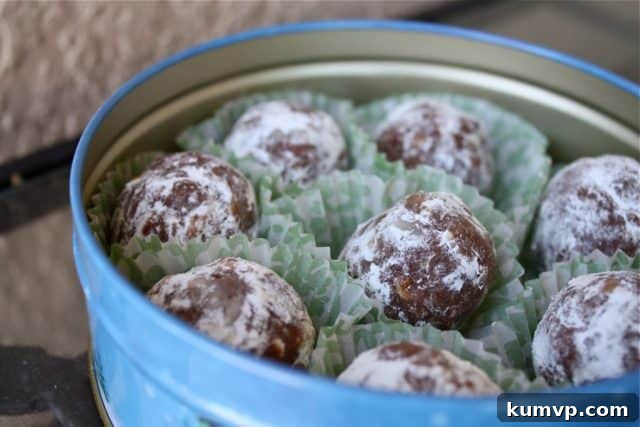 Hand-packed holiday tin filled with individually wrapped no-bake bourbon balls, ready for gifting.