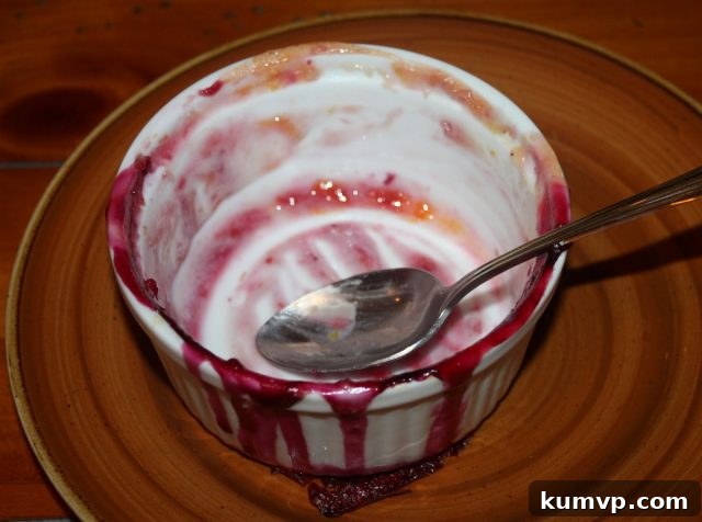 Rustic Peach Blueberry Crumble 3 A generous serving of warm Peach Blueberry Crumble with melting vanilla ice cream in a white bowl