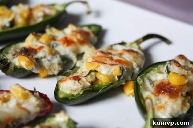 Cheese Corn Stuffed Jalapenos Recipe - Easy Appetizer Golden-brown cheese and corn stuffed jalapenos on a white plate, ready to be served at a party or game day event.