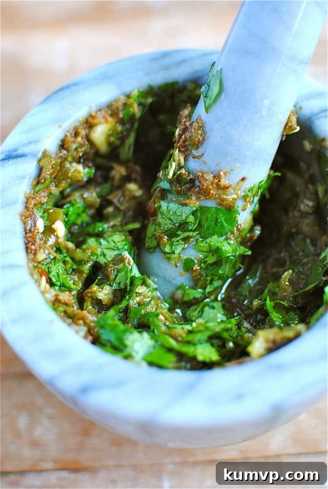 Marinating Shrimp in a Spicy Coriander-Cumin-Jalapeno Paste A bowl of raw, extra-large shrimp, beautifully coated and glistening with the vibrant, homemade spicy marinade, patiently awaiting its transformation in the hot skillet.