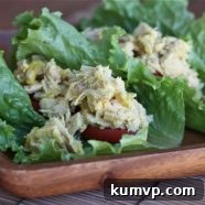 A single Tangy Tuna Salad Wrap, artfully arranged, showcasing its fresh ingredients and inviting appeal.