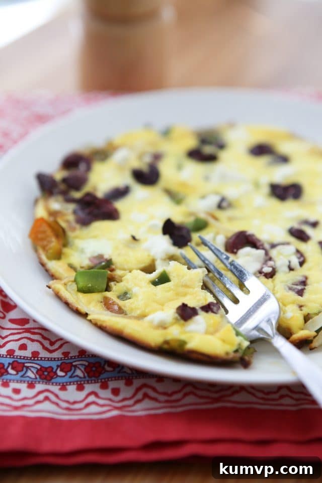 Mediterranean Feta Frittata with Peppers and Onions 2 A beautifully cooked Greek Pepper and Onion Frittata, garnished with fresh herbs, ready for breakfast, lunch, or dinner. A perfect quick, healthy, and low-carb meal for one.