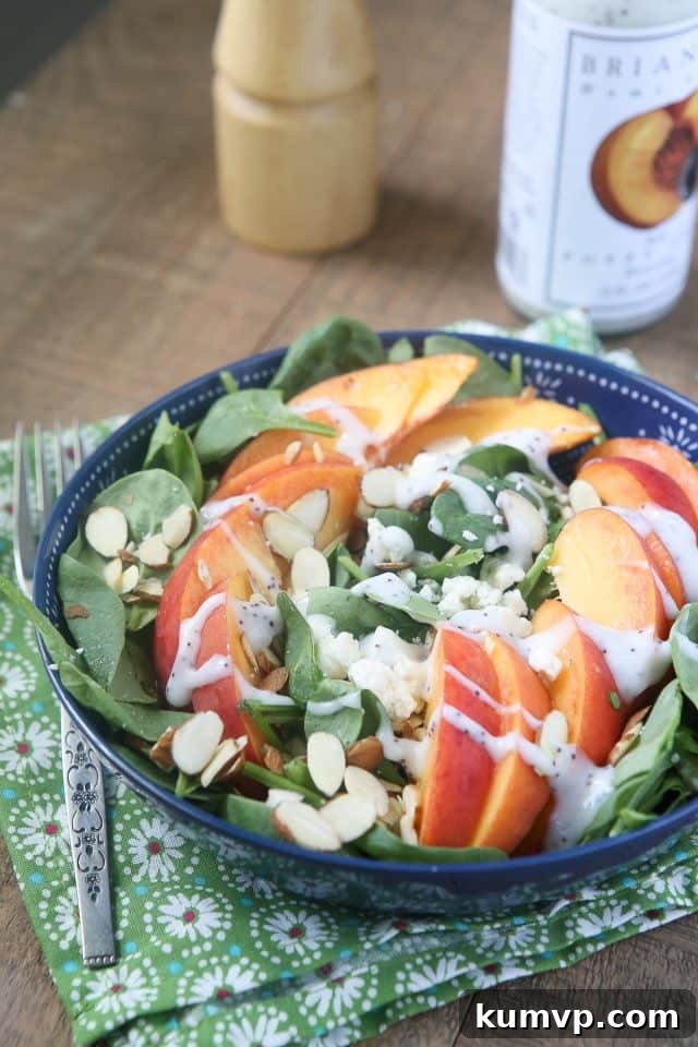 Vibrant Spinach Salad with Fresh Peaches, Tangy Gorgonzola, and Crunchy Almonds, a perfect summer dish